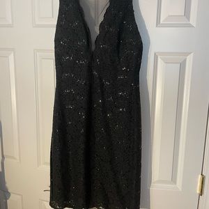Black, sparkly cocktail with low cut v-neck